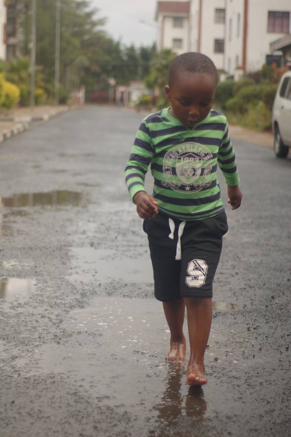 black-girl-walks-in-puddles-bare-foot